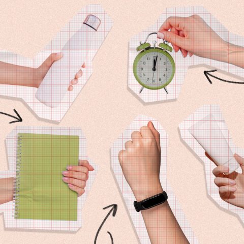 Woman holding a water bottle, alarm clock, journal, sunscreen and a Fitbit watch.