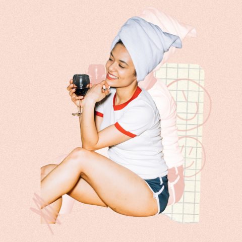 Woman enjoying a glass of wine, joyful smiley face on background