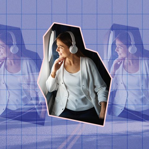 woman wearing headphones on plane with road