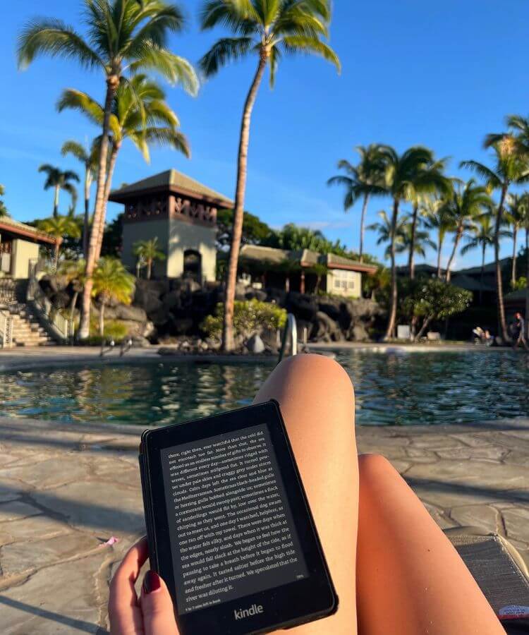 reading by pool on vacation